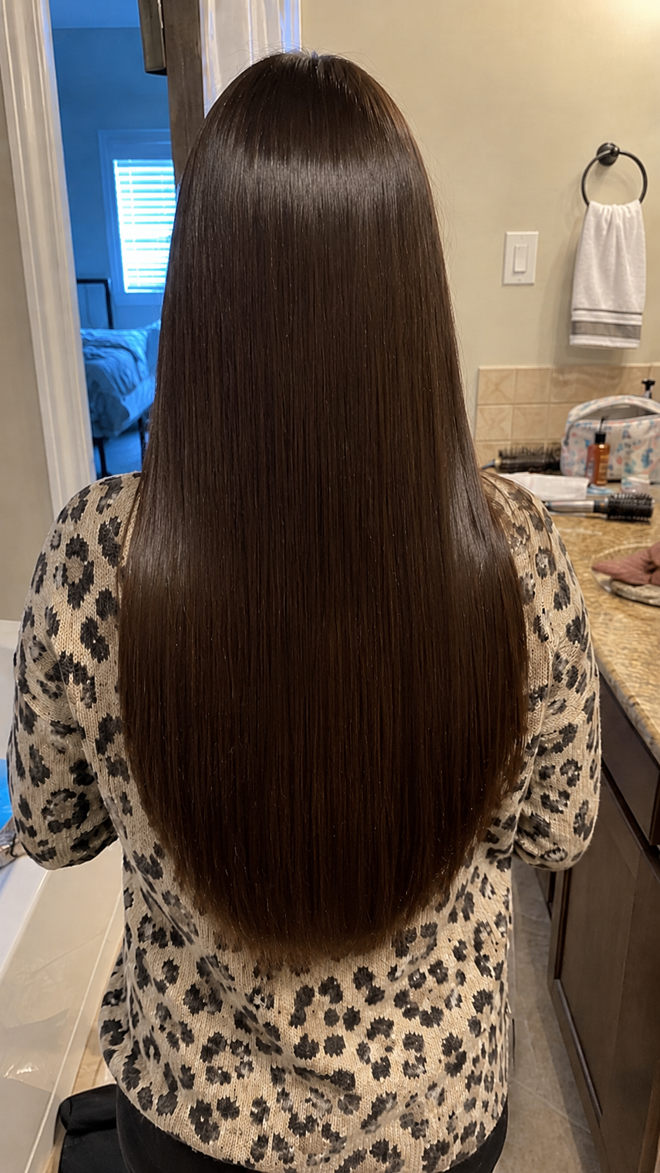 Back view showing straight smooth shiny hair after using hair mask